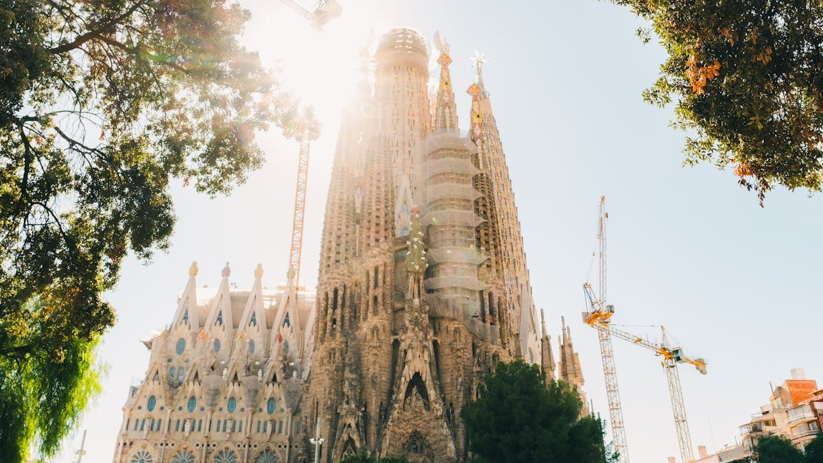 Majestic view of La Sagrada Familia under the bright sun, Barcelona.